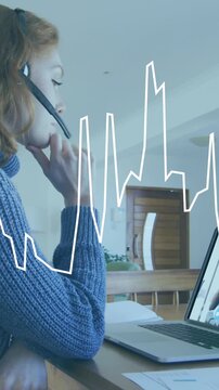 Animation of data processing on graph over caucasian woman at home making laptop video call