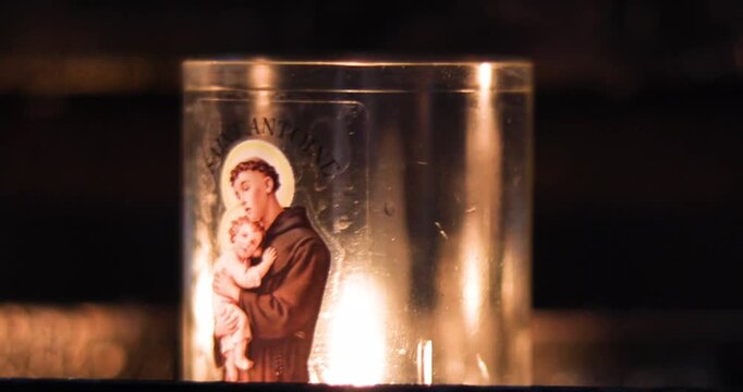 Lit candles with Saint Anthony of Padua and the Christ Child in the church. Prayer for protection.