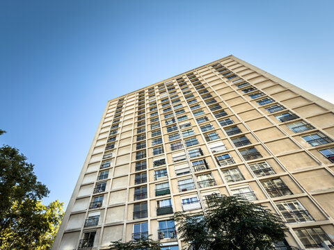 Low-angle view of a Tours Labourdette high-rise on Cours Belsunce, Marseille, france, showing the repetitive concrete facade and balconies of the modern residential complex in central Marseille.