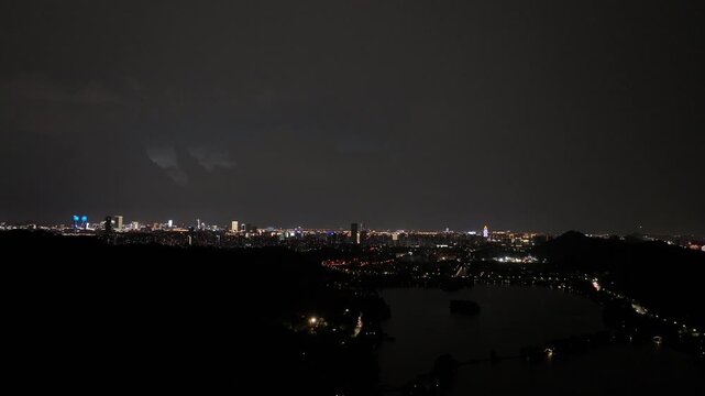 City night view with brilliant lights and lake reflections