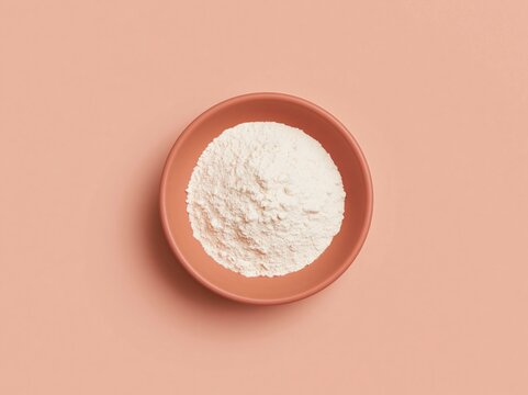 Pink wooden bowl filled with chickpea flour, featuring a fine powdery texture and matte finish, isolated on a solid background with copy space for gluten-free baking and plant-protein packaging