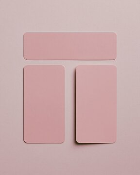 Blank pink bookmarks on a soft mauve paper surface, featuring a smooth matte finish and muted tones for stationery product templates and mockups
