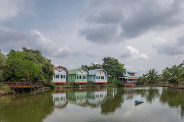 Fototapeta premium colorful holiday homes on a cloudy day, with green trees 