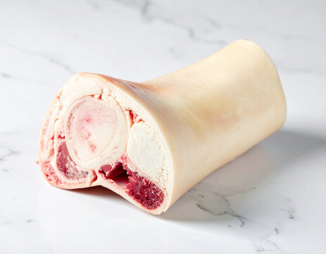 Raw marrow beef bone for stewing or broth, isolated. AI