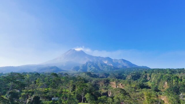 Aerial drone zoom out from merapi mountain volcano peak for peaceful travel video