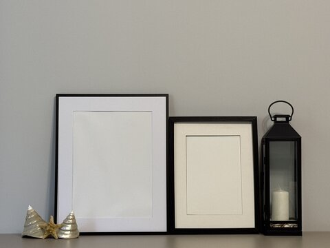 Empty vertical photo frames mockup in coastal style interior