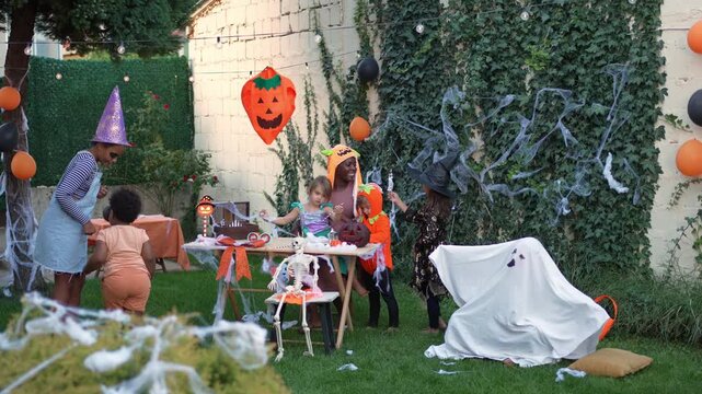 Group of children celebrating a Halloween party in the garden