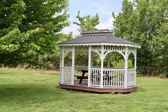 The white gazebo in the park on a sunny day.