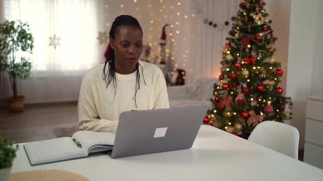 African american woman making a video call during Christmas