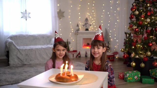 Little girls celebrating birthday together at christmas time