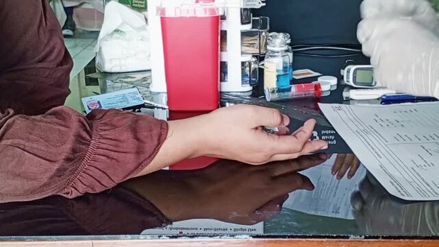 Collecting a capillary blood sample (fingerstick) from the fingertip using a lancet is an initial screening step to check hemoglobin (Hb) levels and determine the donor's blood type.