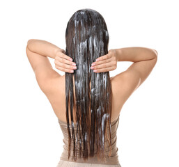Obraz premium Woman applying mask onto her hair against white background, back view