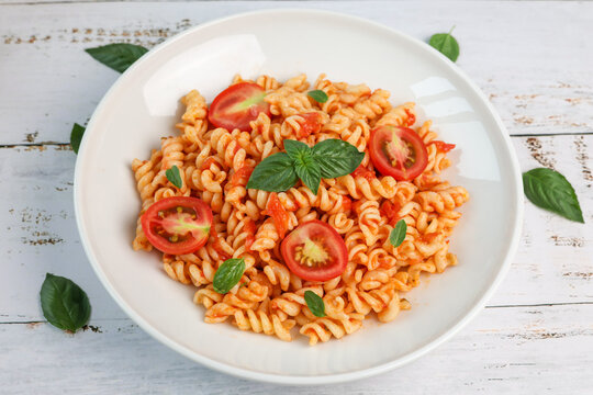 fusilli pasta with tomato sauce and basil