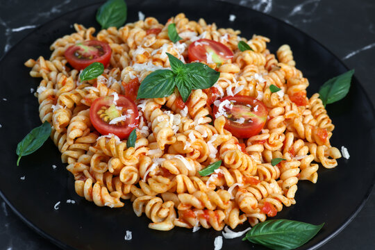 fusilli pasta with tomato sauce and basil