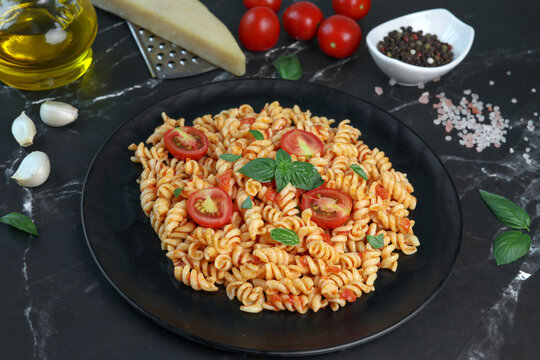 fusilli pasta with tomato sauce and basil