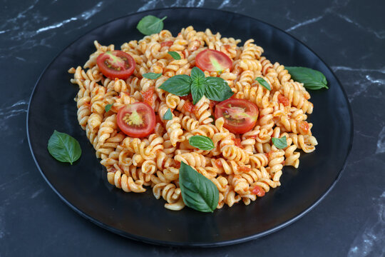 fusilli pasta with tomato sauce and basil