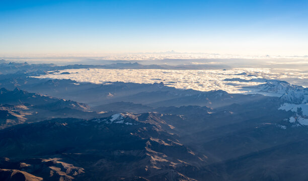 Aerial panorama of the Cordillera La Viuda in the Peruvian Andes. High-altitude mountains near Jauja and Huancayo rise above a vast sea of clouds in Junin, Peru.