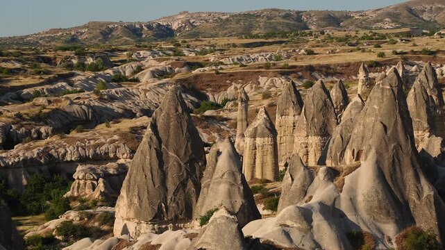 High angle view of unique volcanic tuff rock formations and fairy chimneys in Cappadocia. Love Valley Cappadocia Turkey, geological tourism, historical landmark exploration and wilderness travel