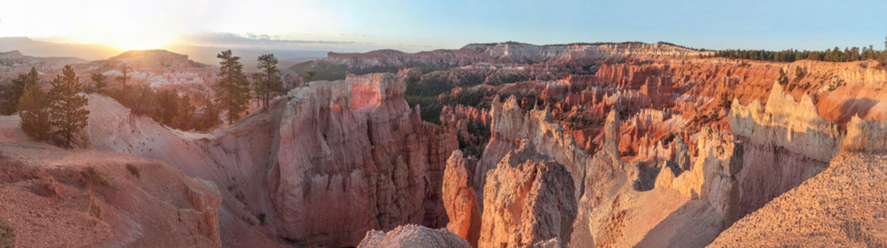 Beautiful wide panoramic view of a canyon rock amphitheater with natural hoodoos spears at sunrise