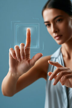 Woman's finger interacting with a futuristic holographic interface on a blue background