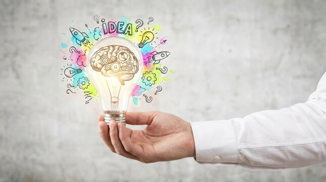 Creative idea sketch featuring a human brain inside a light bulb held by a hand.