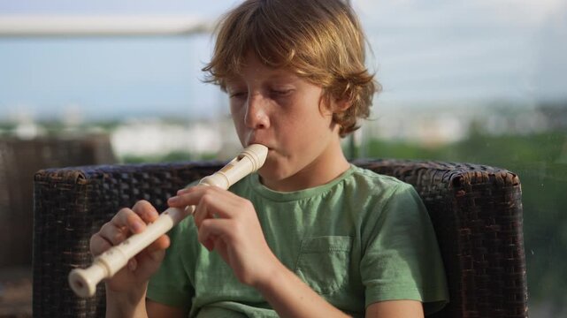 A little boy learns to play the flute at home, practicing with focus and enthusiasm in a cozy, warm setting. A charming scene of early musical exploration, creativity, and childhood growth.