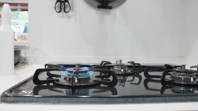 Cleaning Gas Burner with Cloth Close Up in Kitchen