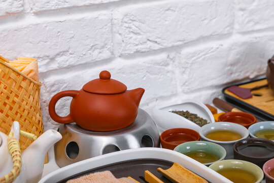 Traditional chinese tea ceremony setup with yixing clay teapot on stand. Authentic chaban bamboo tea tray with ceramic cups and tea leaves. Eastern culture ritual and relaxation theme