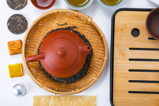 Traditional clay teapot on bamboo tray for Chinese tea ceremony. Authentic puerh tea presentation with dry leaves and ceramic cups. Asian culture relaxation and zen meditation lifestyle