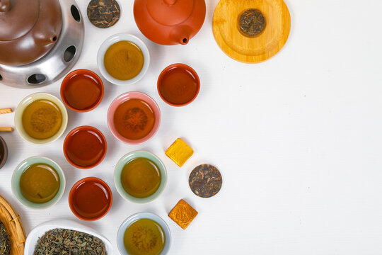 Traditional chinese tea ceremony set with yixing clay teapot and puerh tea cups. Authentic asian tea culture background with chaban bamboo tray. Flatlay display of herbal tea ritual