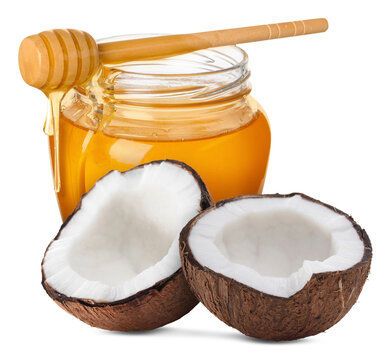Honey in jar, dipper and coconut halves on white background