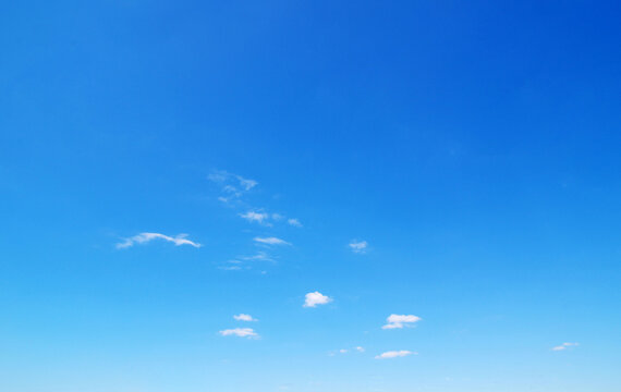 Blue sky background with a tiny clouds