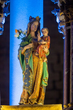 A polychrome statue of Virgin Mary holding the infant Jesus.