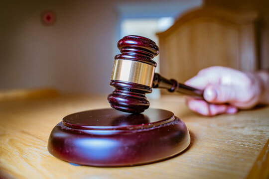 Macro Close-up of Judge's Gavel and Sound Block on Courtroom Table