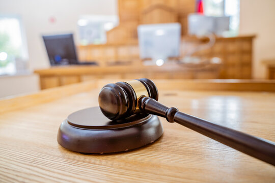 Judge's Gavel Resting on Sound Block in Empty Courtroom