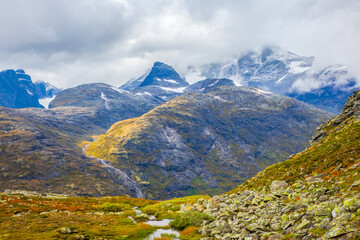 Fototapeta premium Cloudy skies over mountains and valleys in Norway during a quiet afternoon