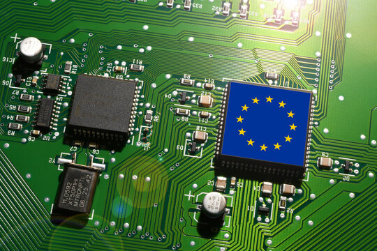 EU flag on a microchip of a computer motherboard card. Concept representing the global battle for microchip production and technological supremacy.
