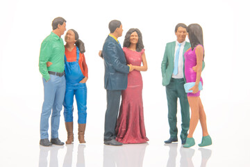 Fototapeta premium Miniature people gather in a social setting during a festive event with colorful outfits and various poses