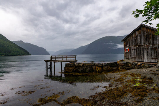 A beautiful summer  landscape with a village buildings by the fjord . A summer scenery of World Heritage Area in Western Norway.