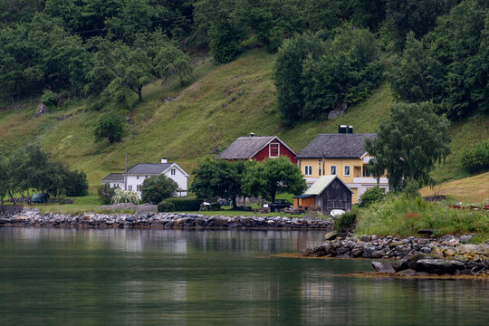 A beautiful summer  landscape with a village buildings by the fjord . A summer scenery of World Heritage Area in Western Norway.