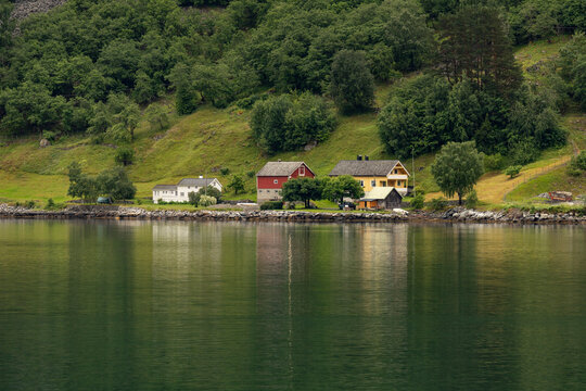A beautiful summer  landscape with a village buildings by the fjord . A summer scenery of World Heritage Area in Western Norway.