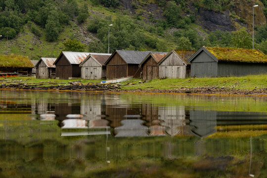 A beautiful summer  landscape with a village buildings by the fjord . A summer scenery of World Heritage Area in Western Norway.