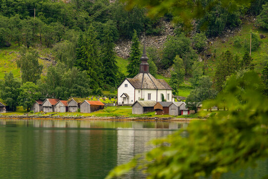 A beautiful summer  landscape with a village buildings by the fjord . A summer scenery of World Heritage Area in Western Norway.