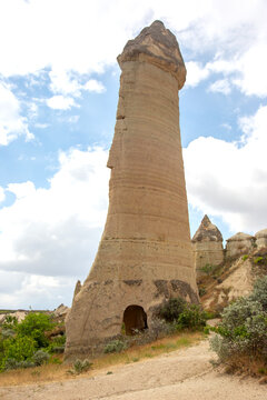 Tall rock formation in Cappadocia, Turkey under cloudy sky