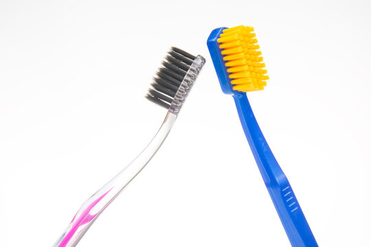 Two toothbrushes placed side by side in a simple and clean setting
