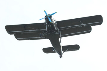 Plane flies overhead in clear sky during daytime © photosaint