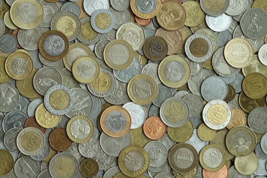 Big pile of coins from different money currencies. Treasure and numismatics concept