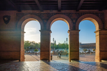 Naklejka premium Sunset view through the arches of Plaza de Espana in Seville
