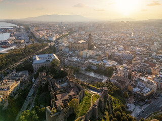 Fototapeta premium Aerial view of Malaga cityscape at sunset with the Alcazaba