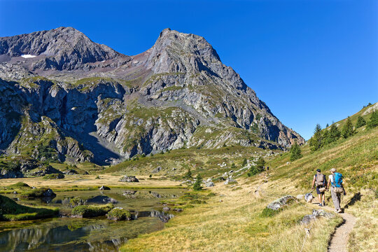 TAILLEFER, FRANCE, August 24, 2026 : Couple of hikers on the paths of Plateau des Lacs du Taillefer, a well-know hiking track